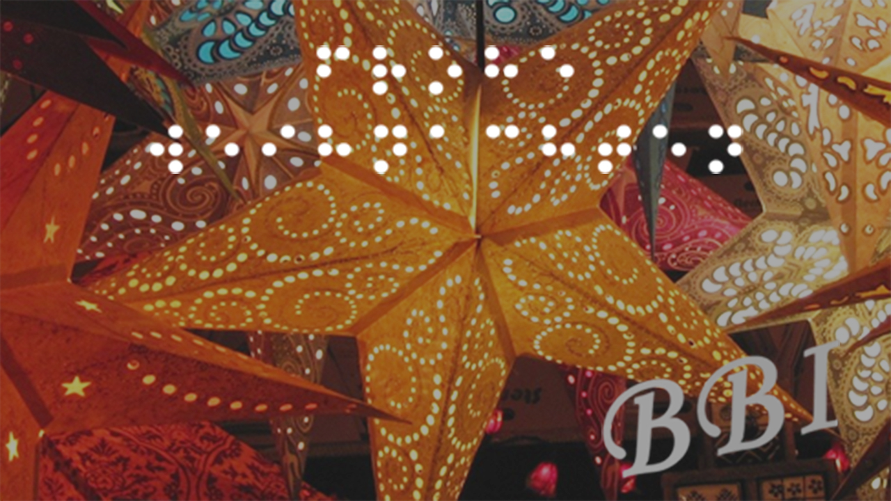 Bild mit bunten, beleuchteten Sternen Text: Frohe Weihnachten (in Brailleschrift). BBI